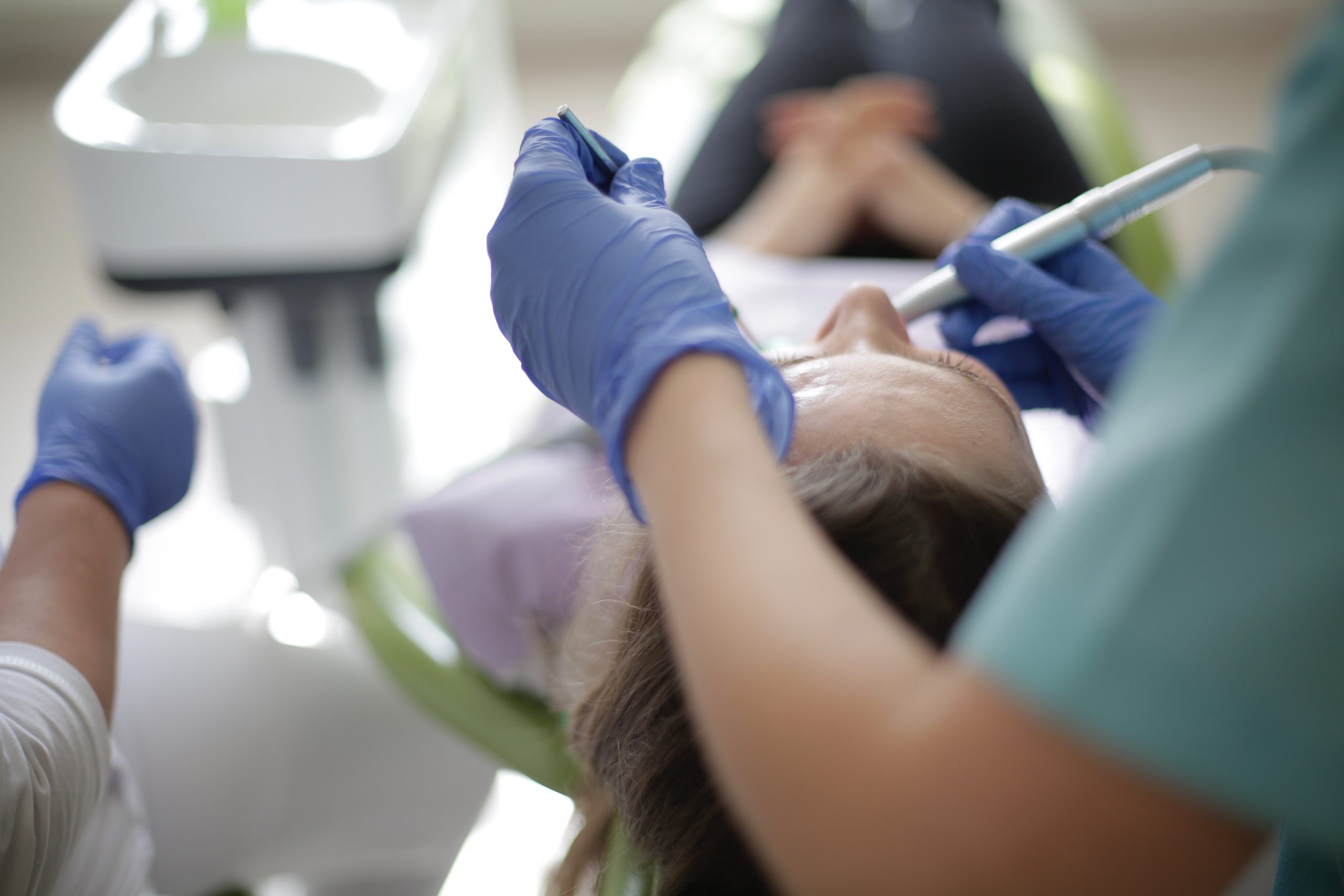 anonymous dentist using drill and mouth mirror for dental 3946835 root canal under process