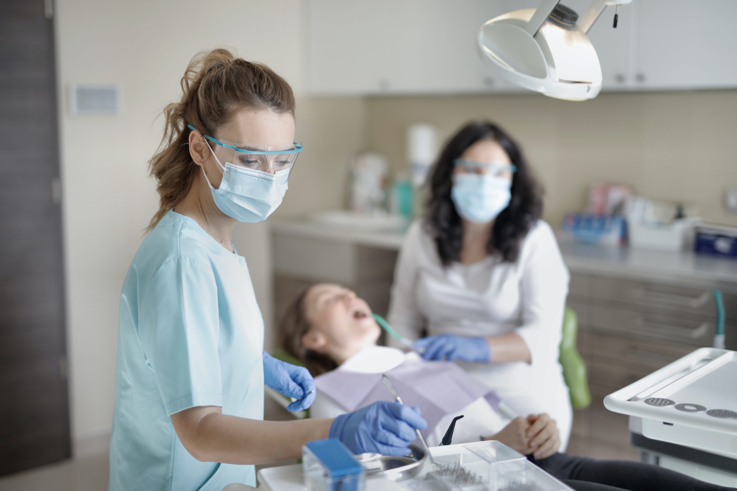 female dentist treating her patient 3881325 prepping for tooth extraction